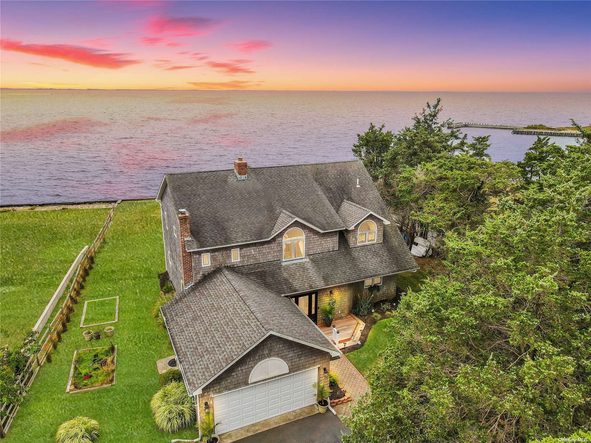 an aerial view of a house with a garden and lake view