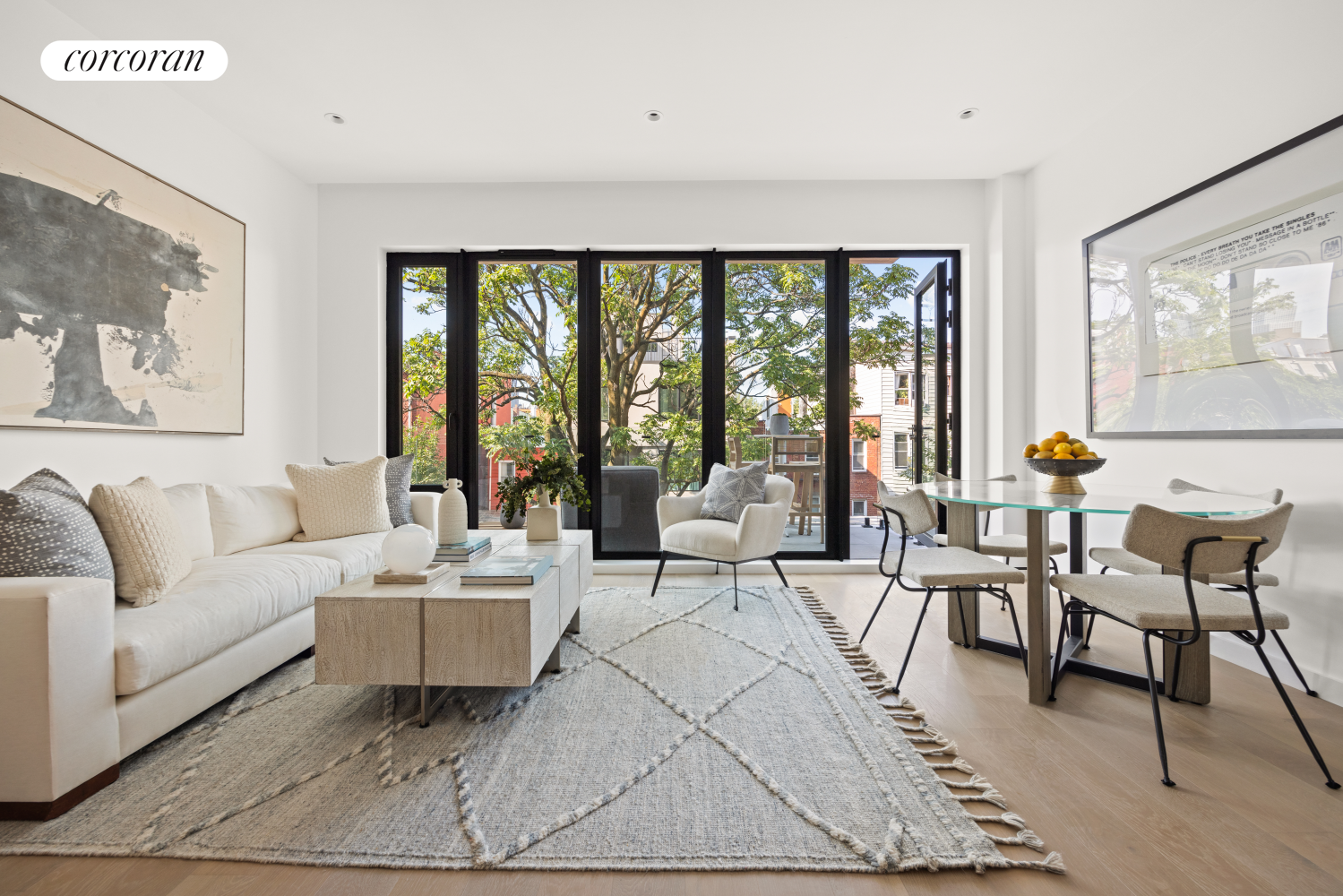 a living room with furniture and large windows