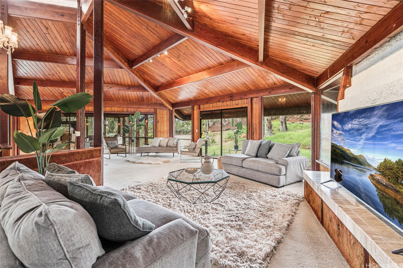 a living room with furniture and a floor to ceiling window