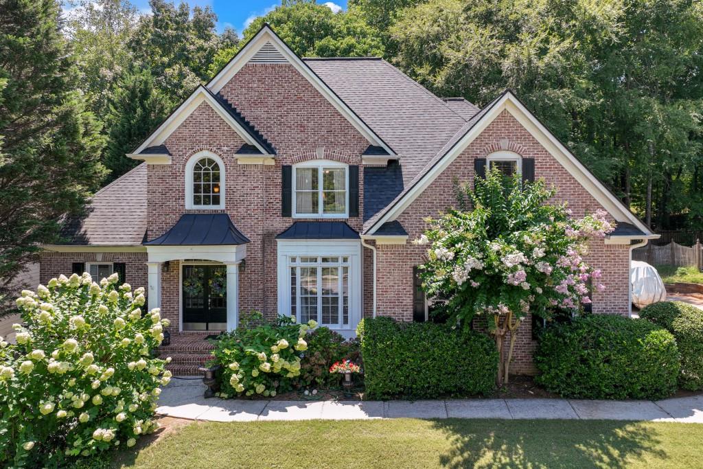 a aerial view of a house with a yard and potted plants