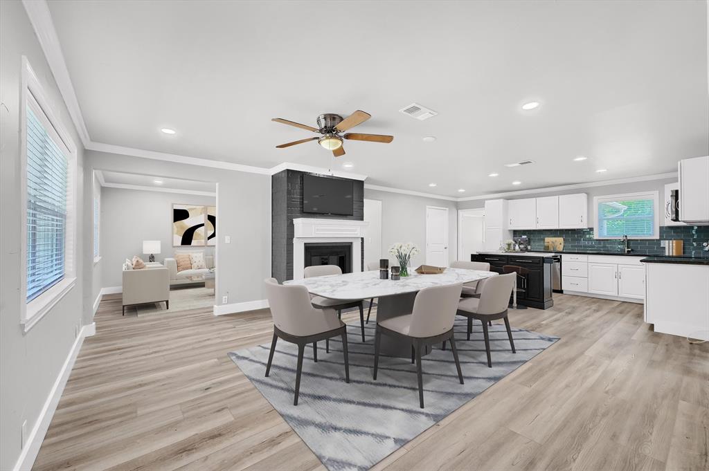 a living room with furniture a fireplace and kitchen view