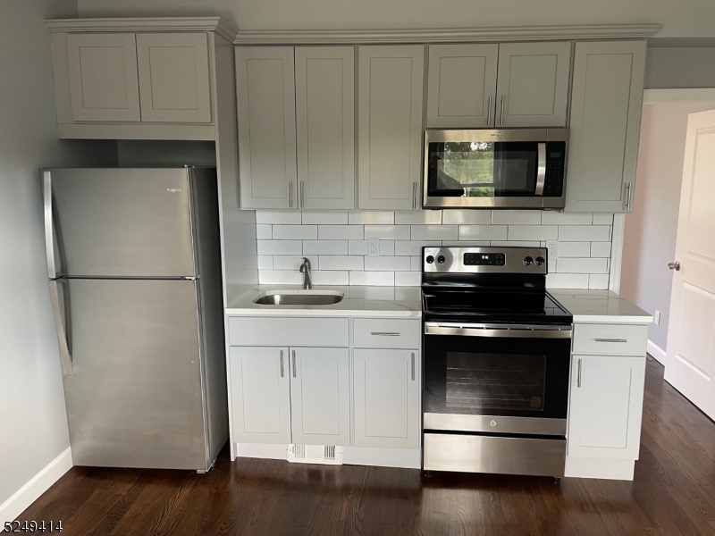 a kitchen with a refrigerator stove and microwave