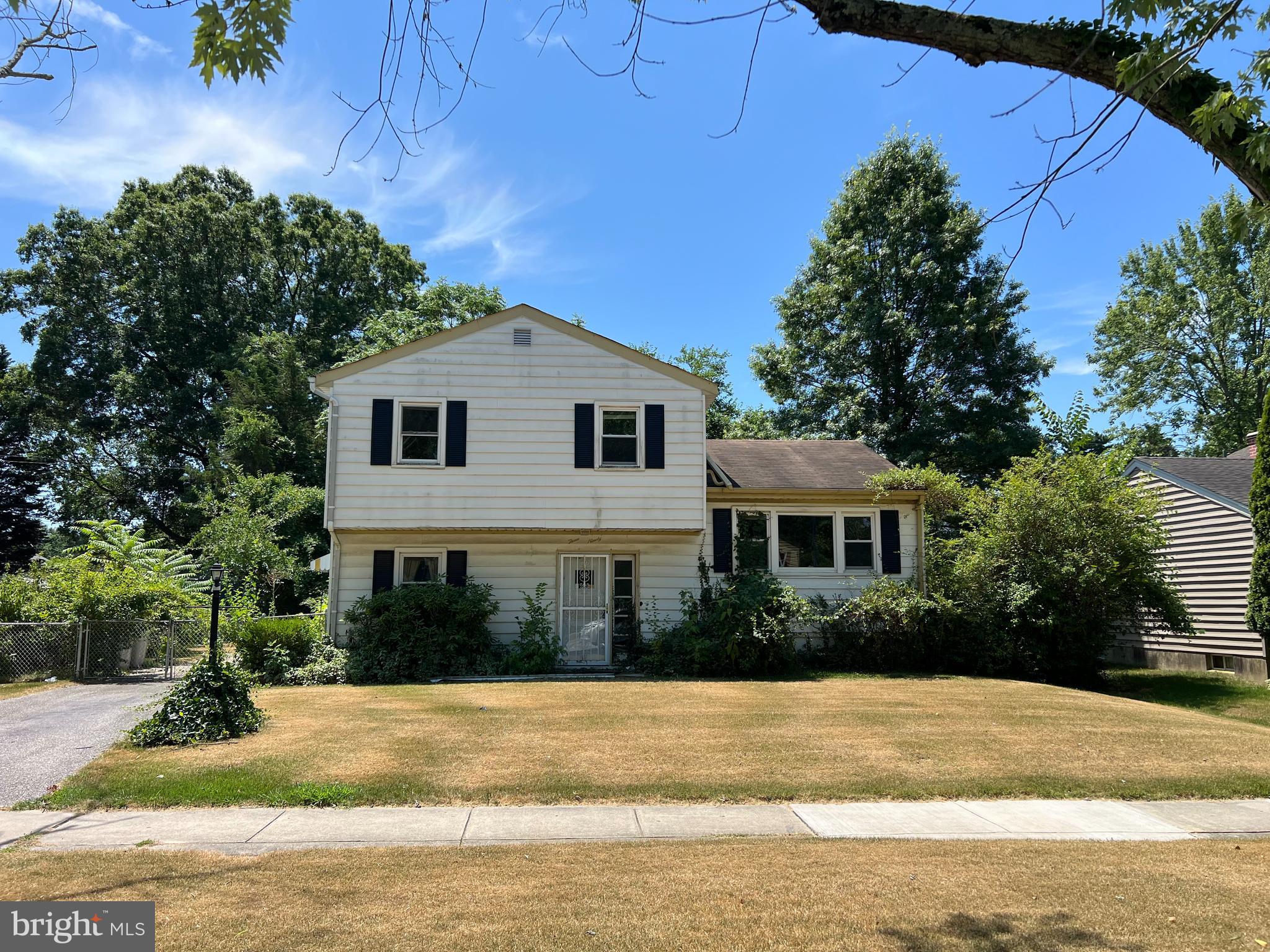 a front view of a house with a yard and potted plants