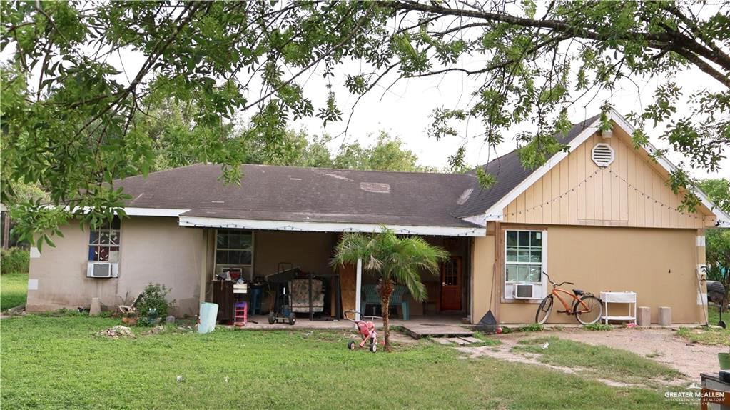 a view of a house with backyard porch and sitting area