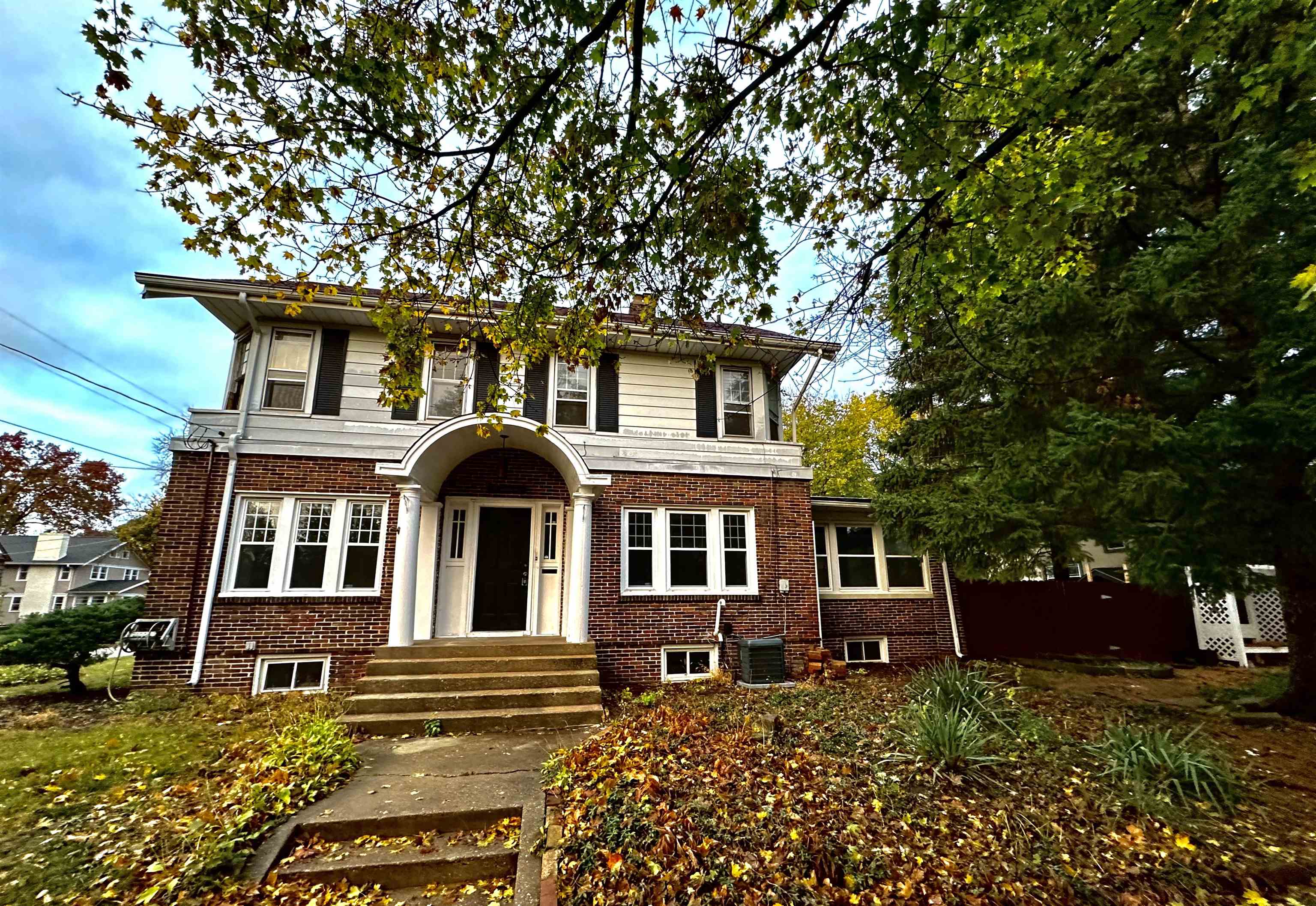 front view of a house with a tree