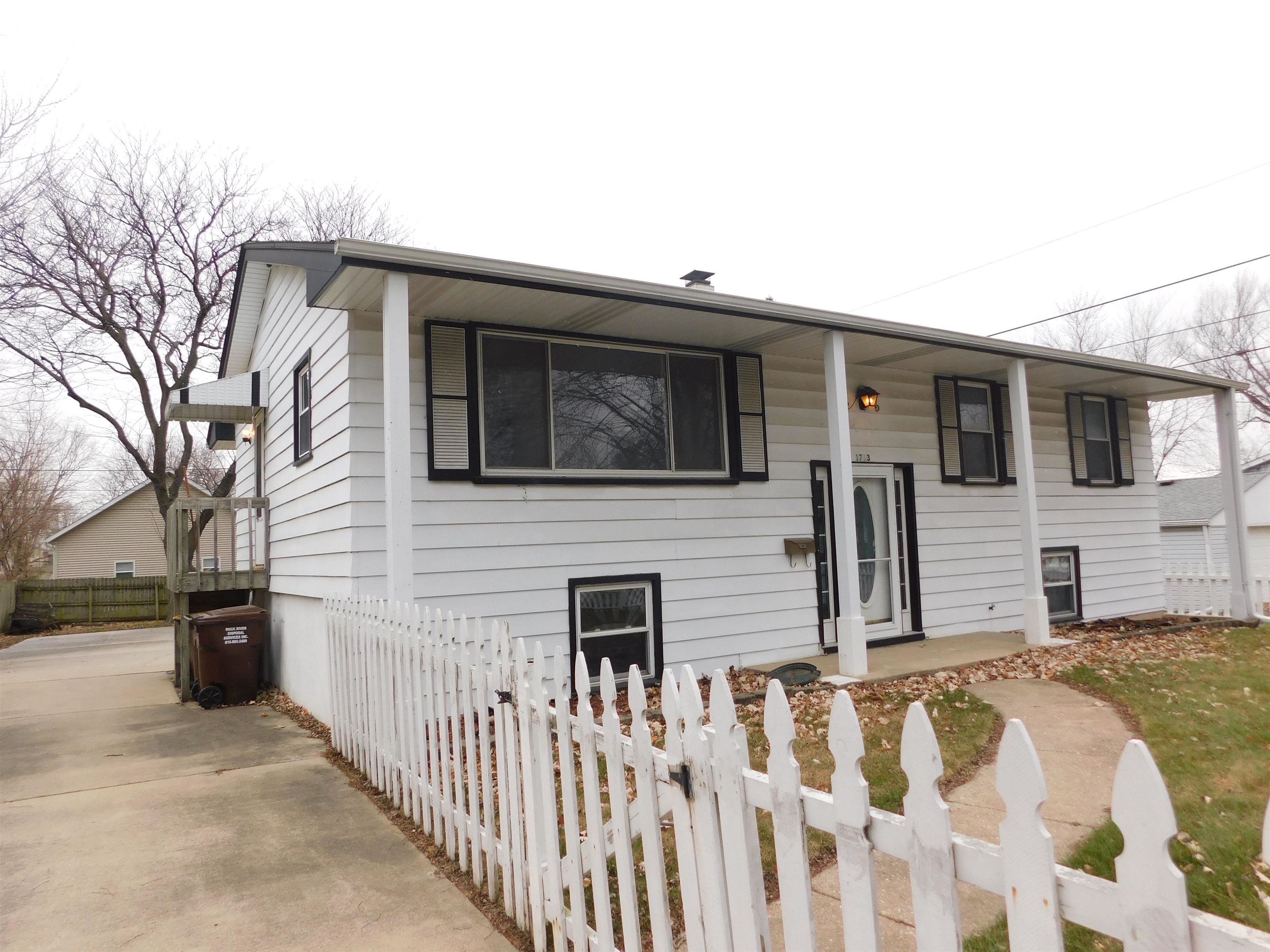 a view of a house with wooden fence