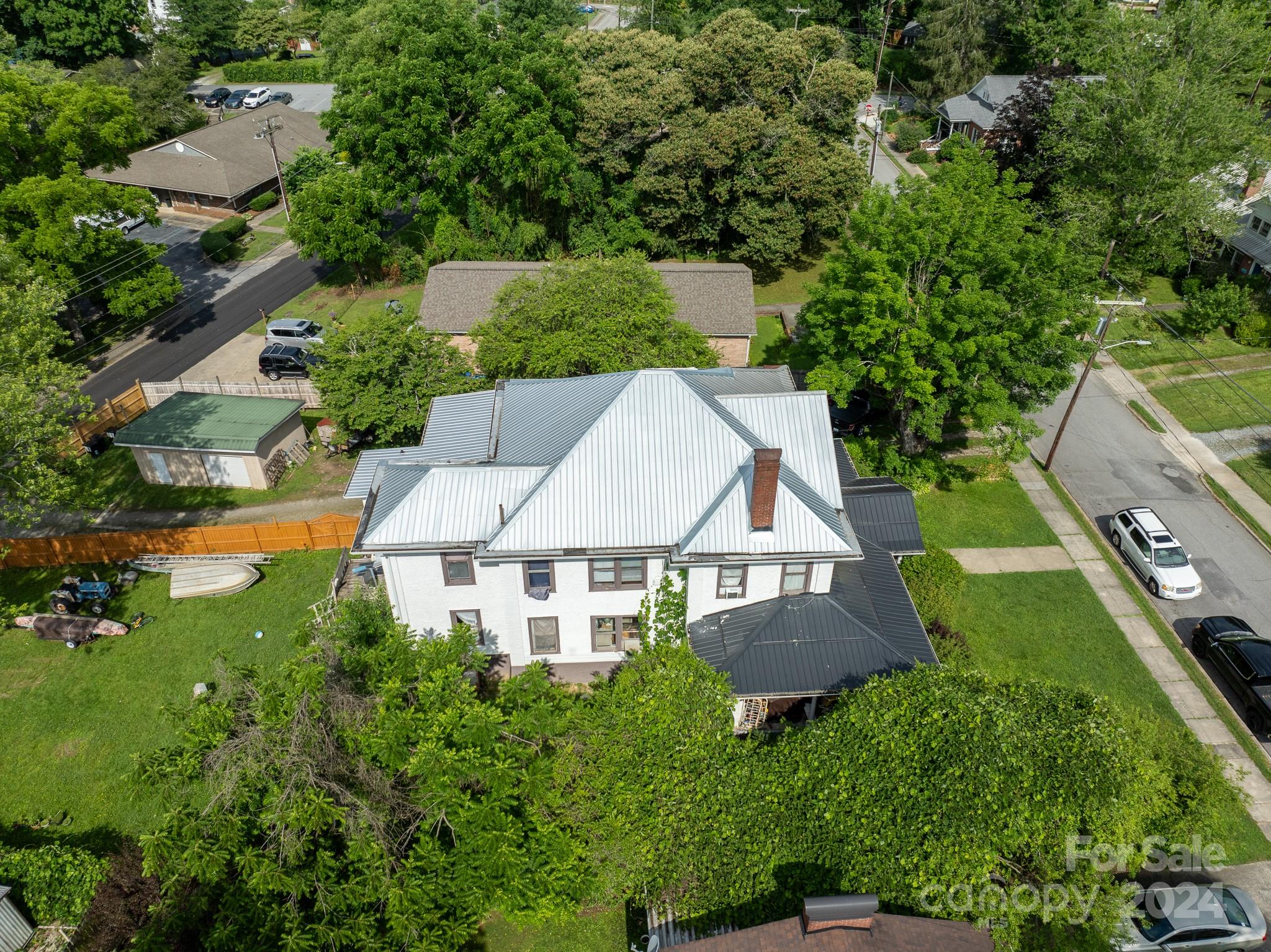 an aerial view of a house with yard and outdoor seating