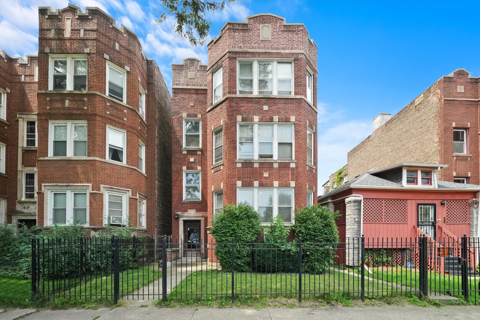 a front view of a residential apartment building with a yard