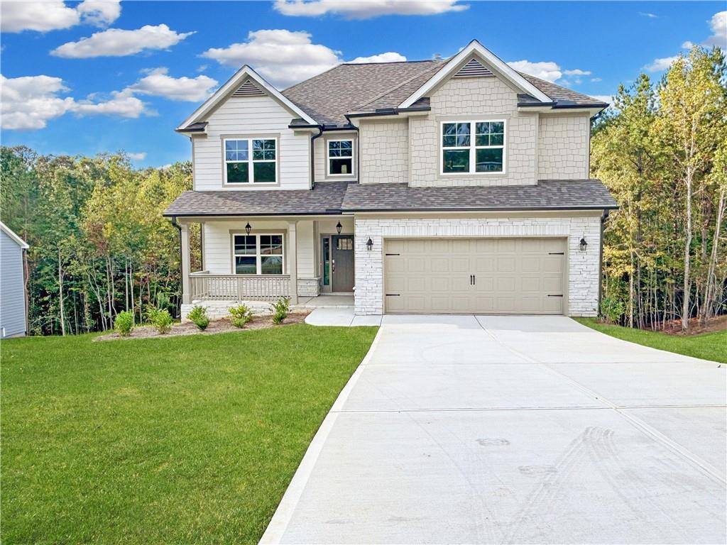 a front view of a house with a yard and garage