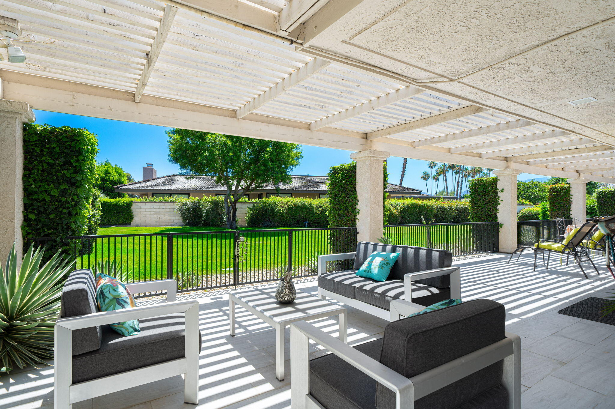 a view of a patio with a table chairs and a backyard