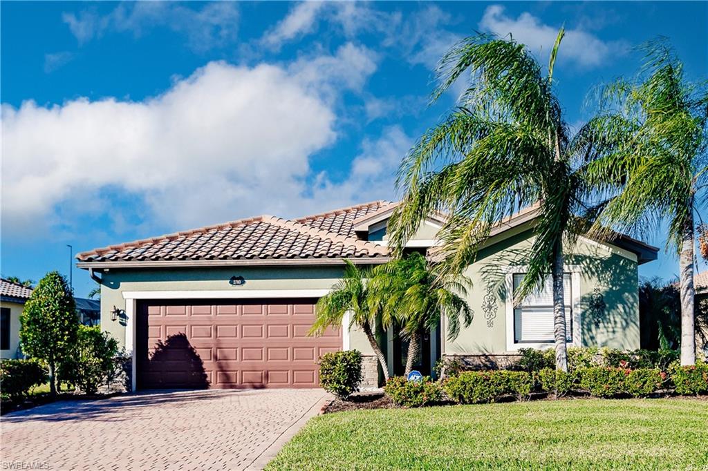 View of front of house featuring a garage and a front yard