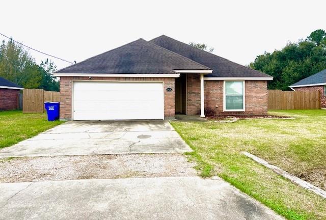 a front view of house with yard and garage