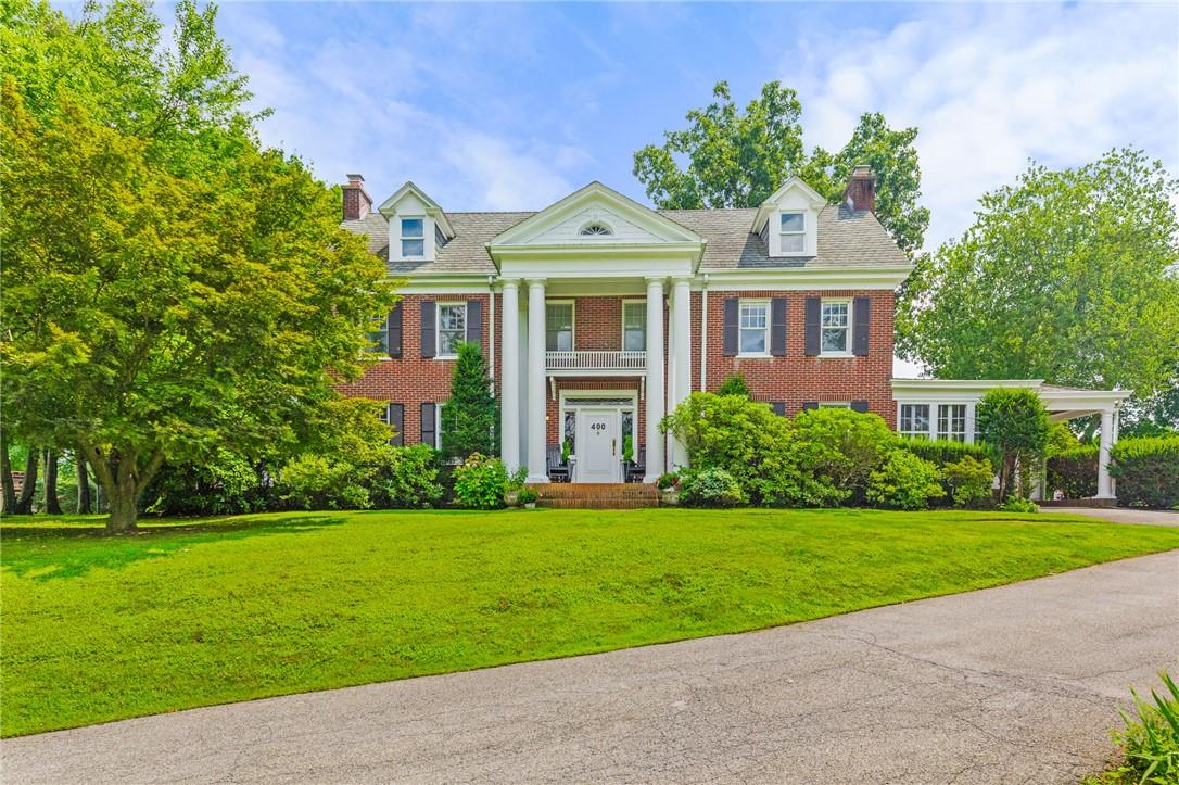 a front view of a house with a garden