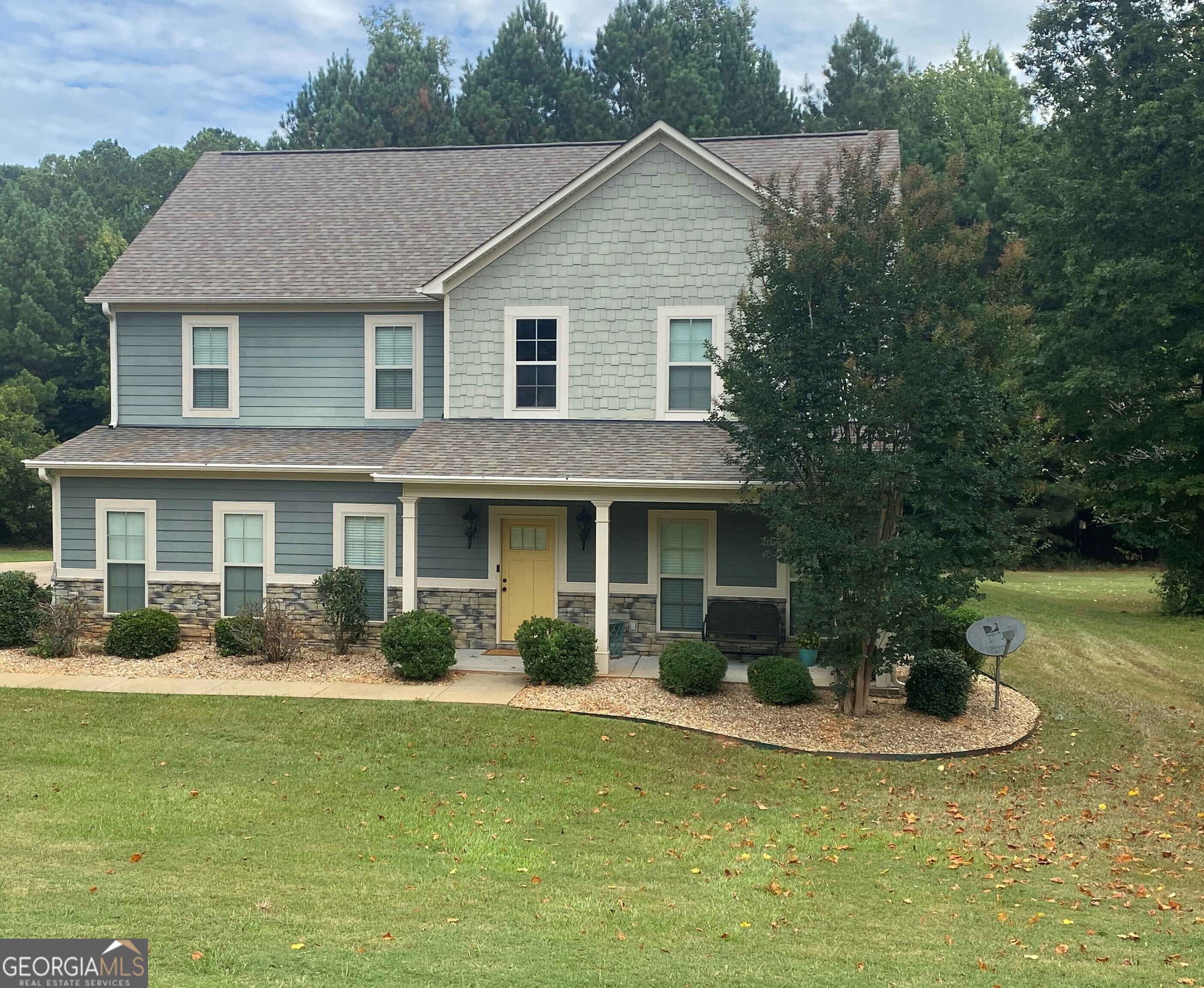 a front view of a house with garden