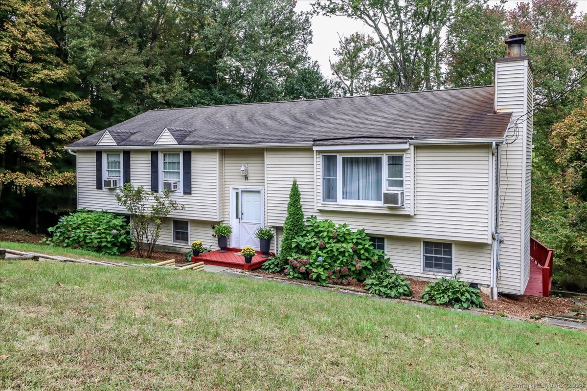 a front view of house with yard and green space