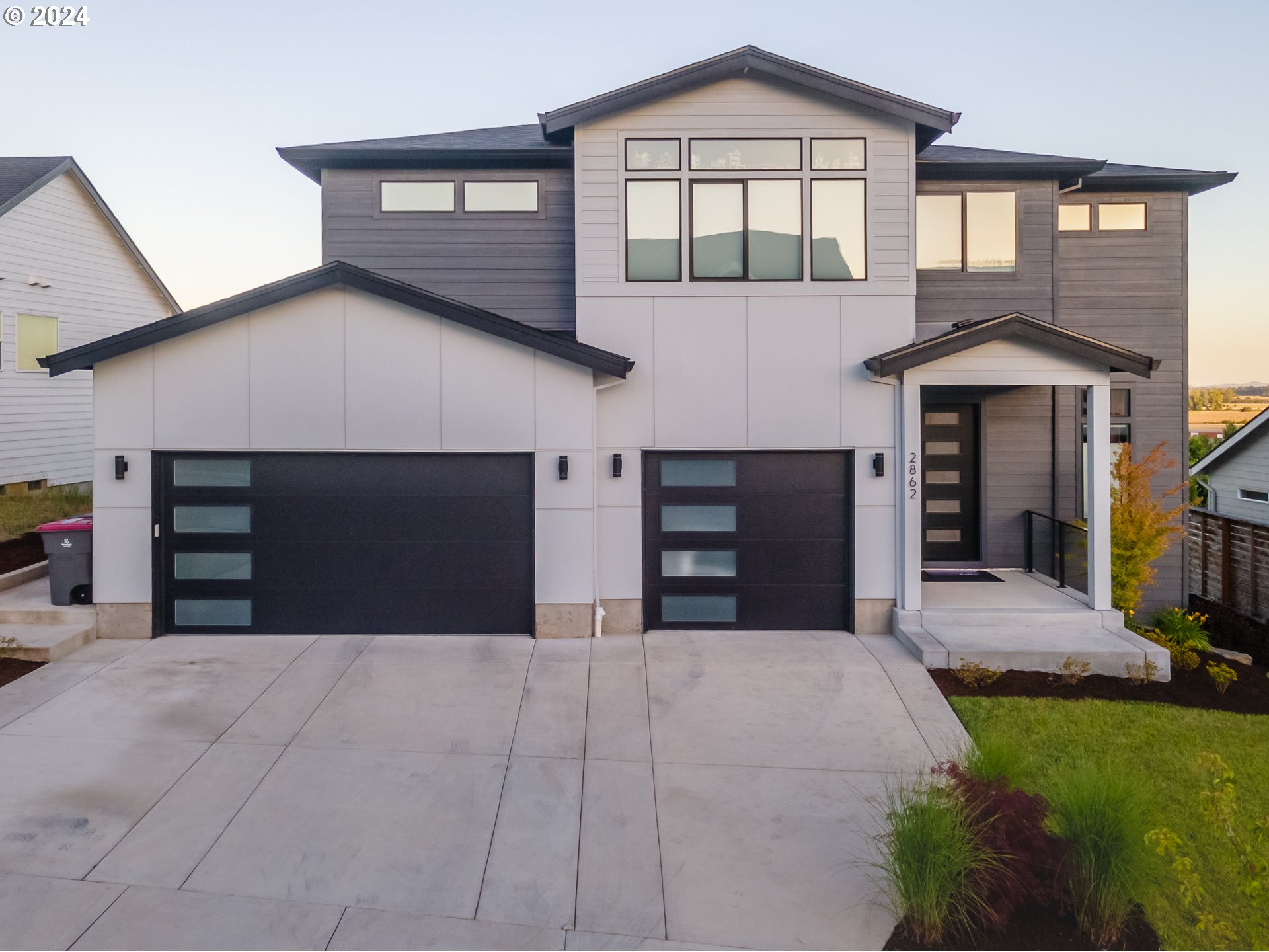 a front view of a house with a yard and garage