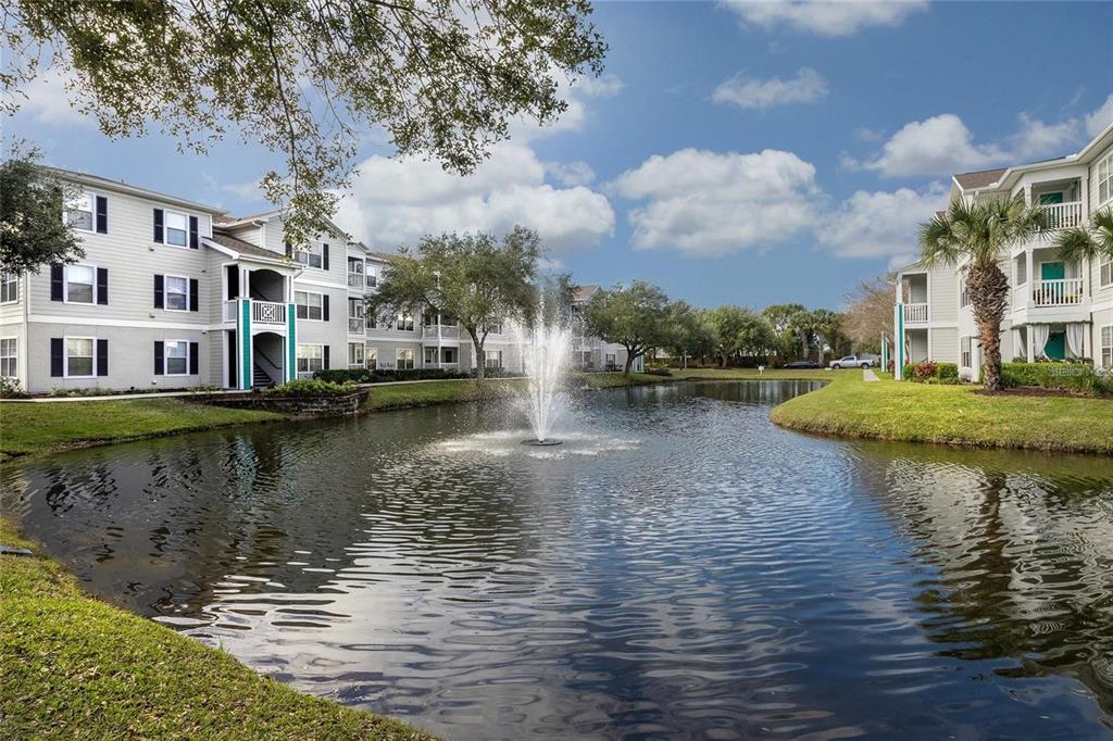 a view of building with river in front of house