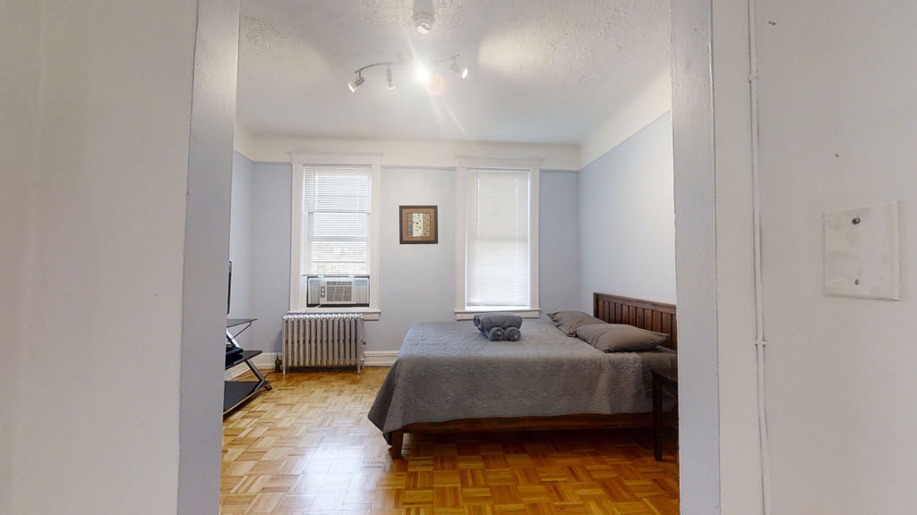 a bedroom with bed and window