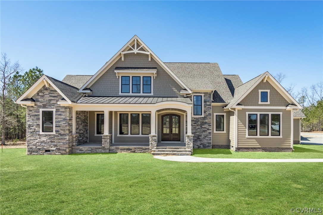 Craftsman house with a front lawn