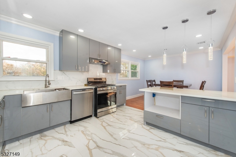 a kitchen with stainless steel appliances kitchen island granite countertop a sink and cabinets