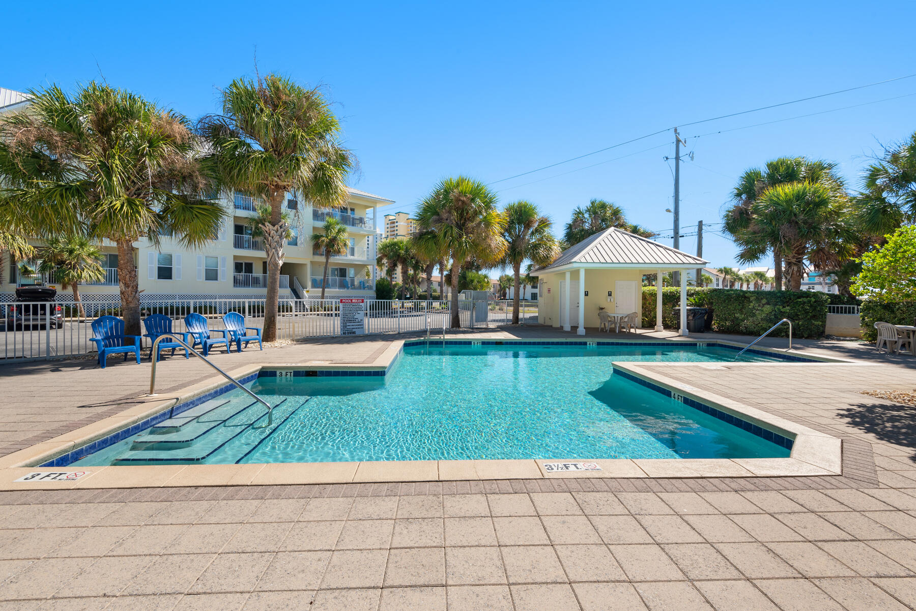 a view of a house with a swimming pool and sitting area