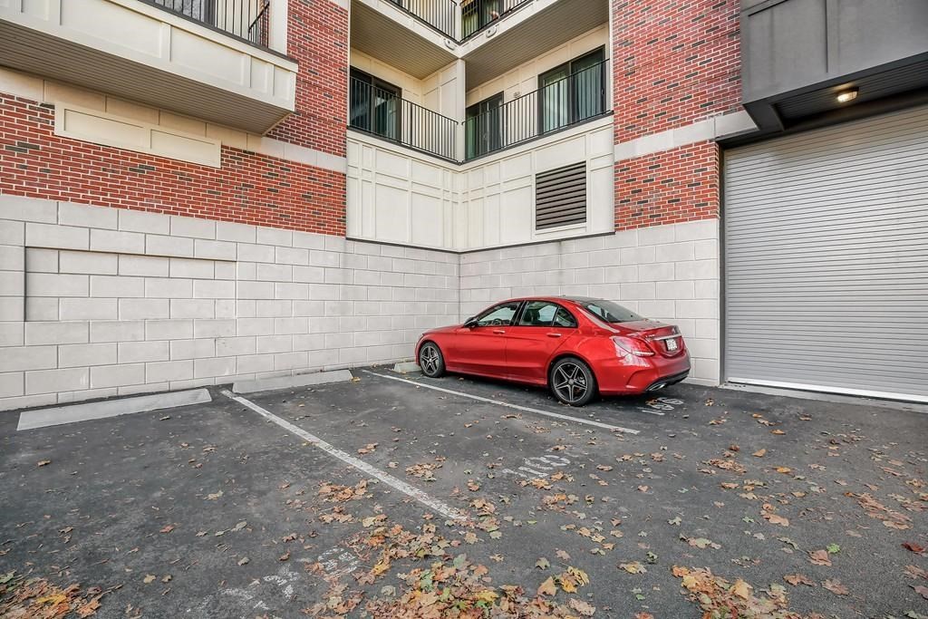 a car parked in front of a brick building