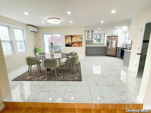 a living room with stainless steel appliances kitchen island granite countertop furniture and a dining table