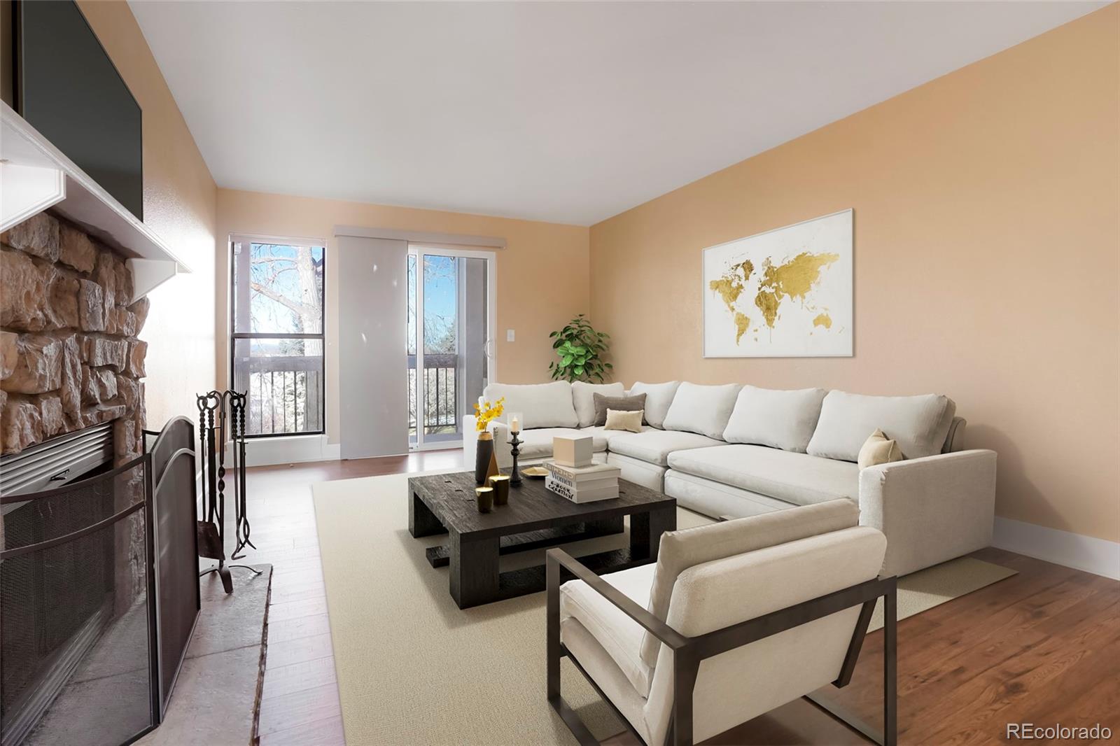 a living room with furniture a flat screen tv and a refrigerator