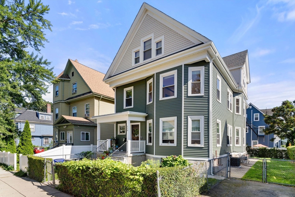 a front view of a residential apartment building with a yard