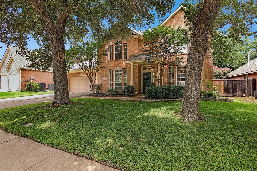 a view of a house with backyard and a tree