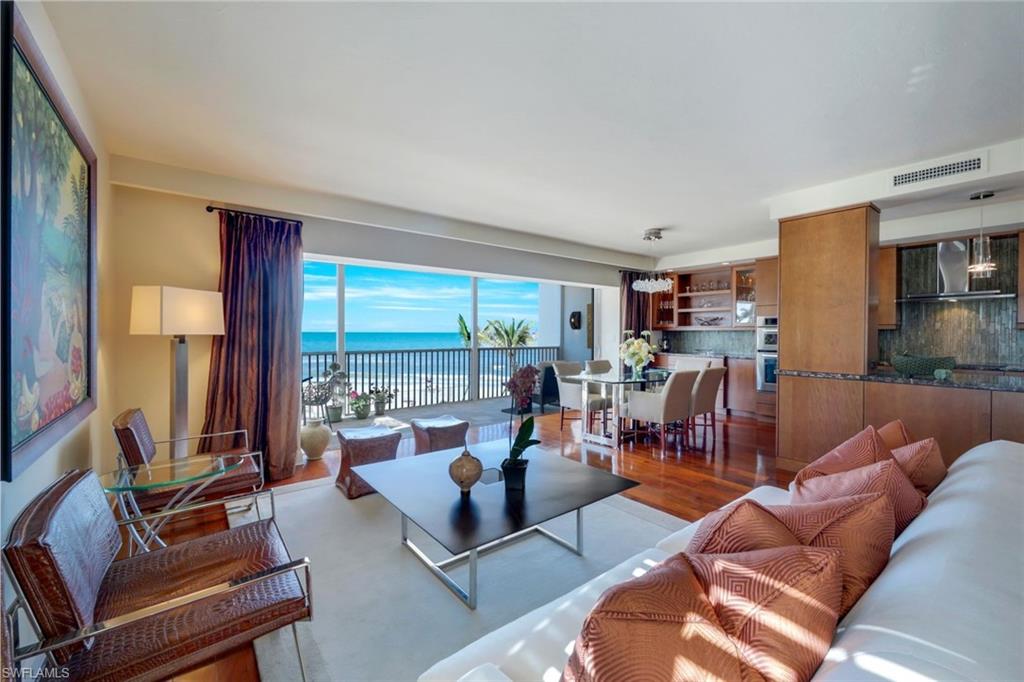 a living room with furniture and floor to ceiling windows