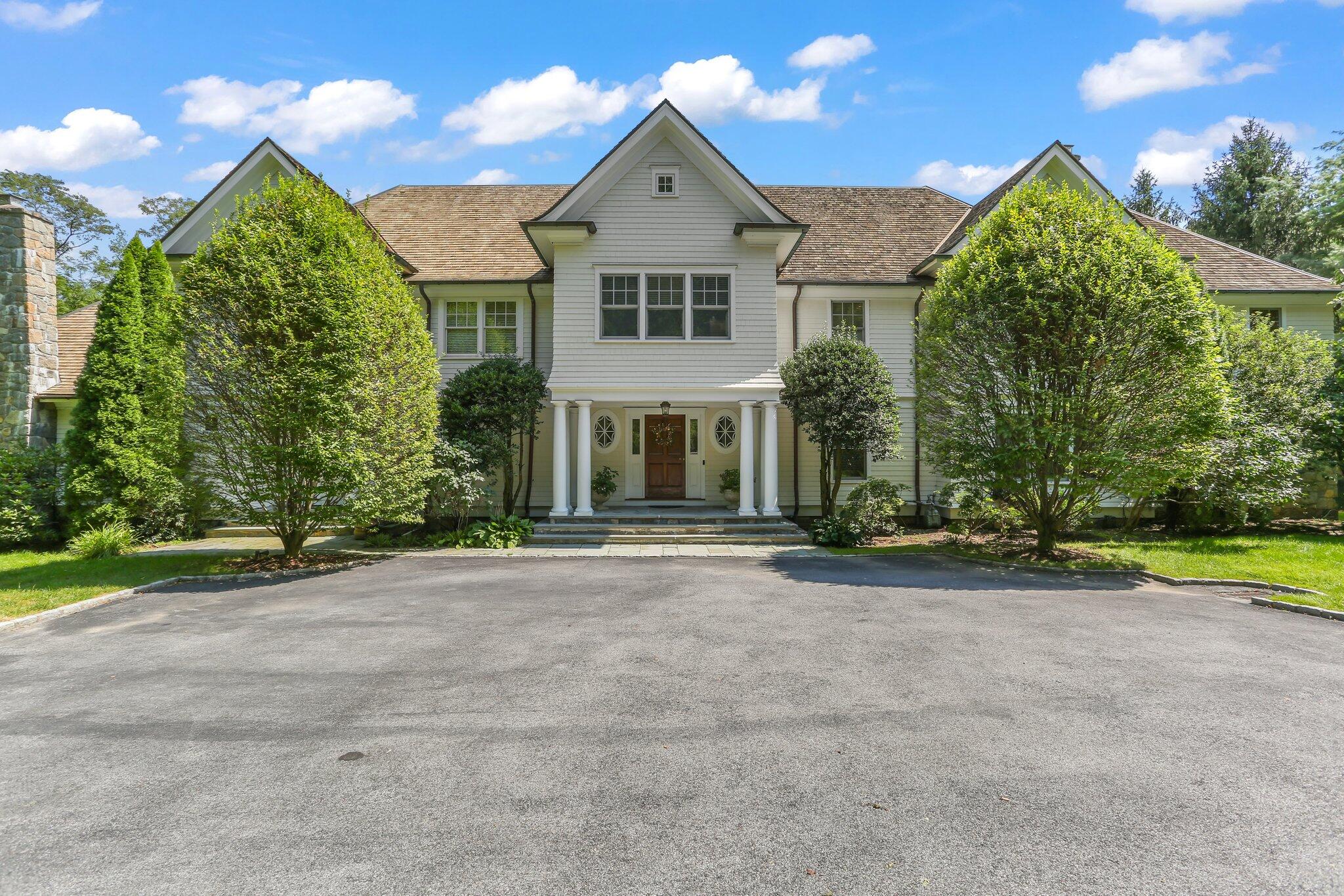 a front view of a house with garden