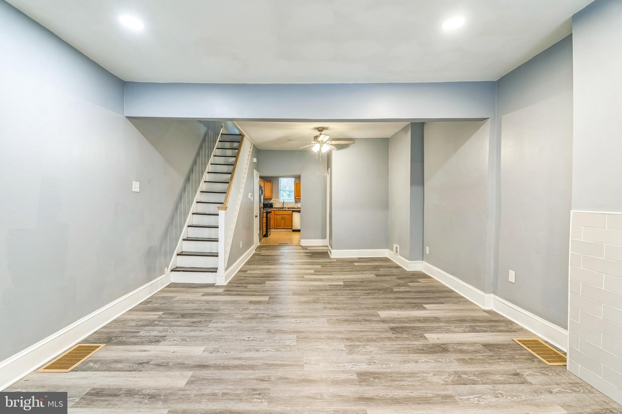 a view of an empty room with stairs and ventilation