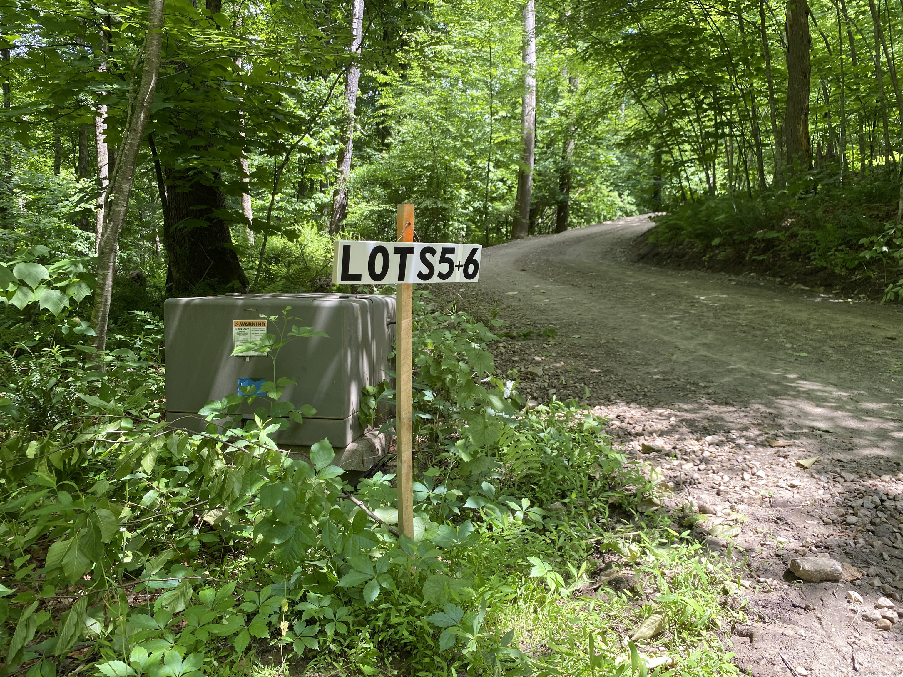 a sign that is sitting in the middle of a forest