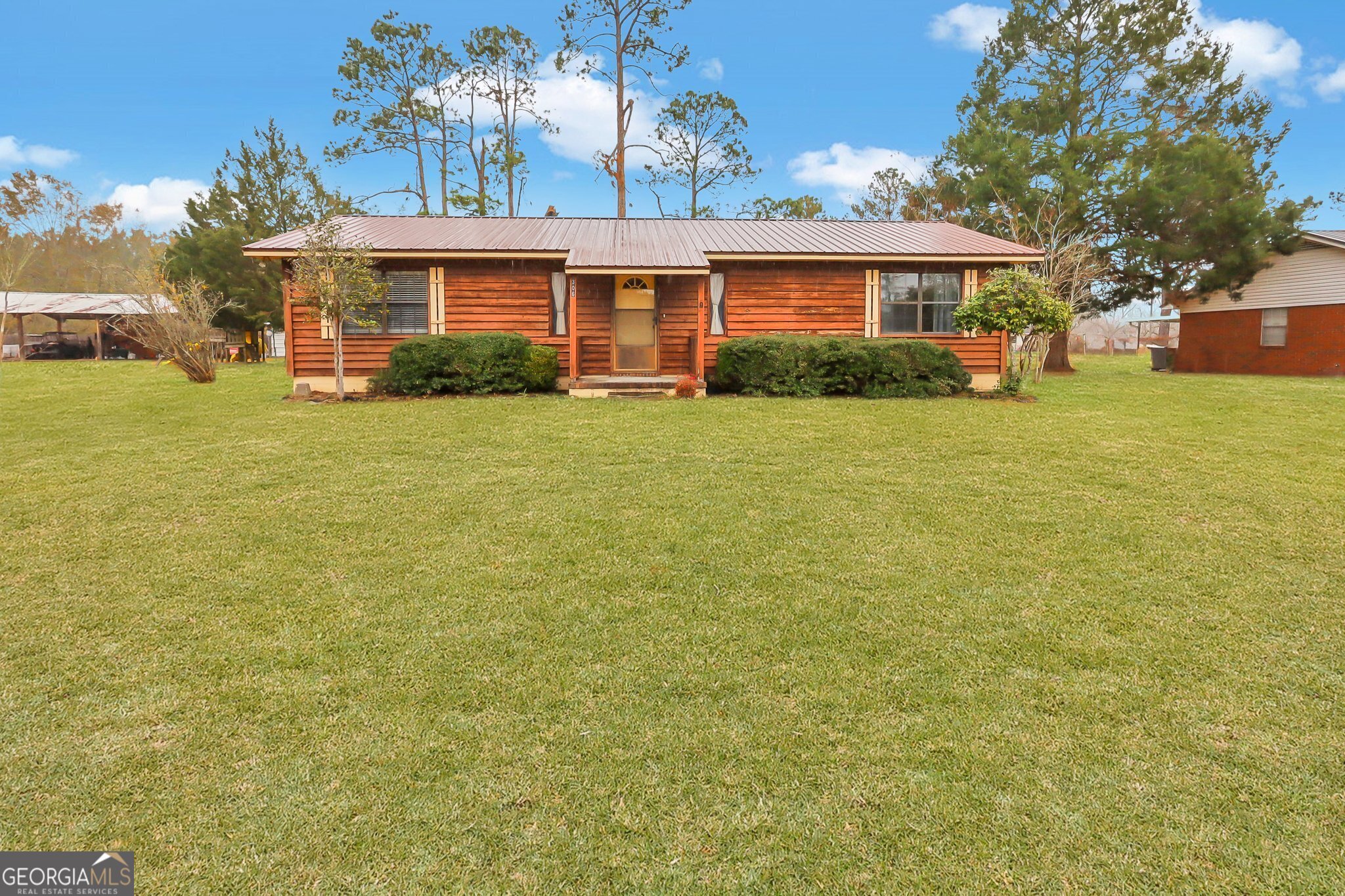 a front view of house with yard and trees