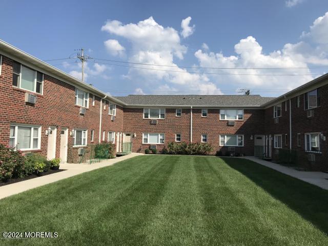 a view of house with yard in front of house