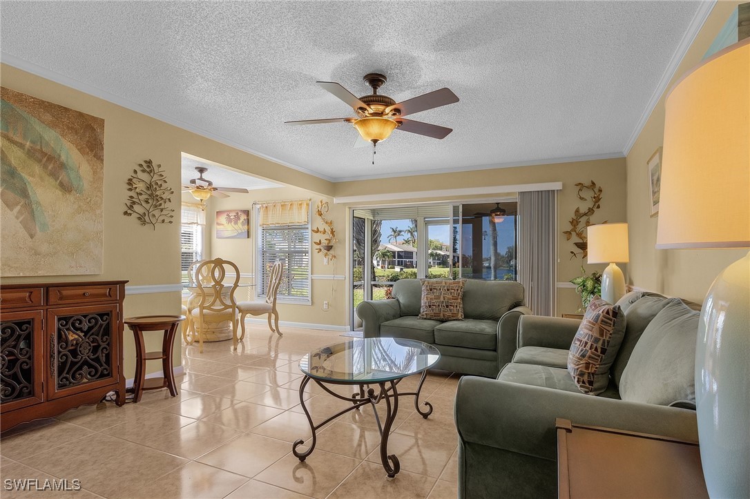 a living room with furniture a chandelier and a window