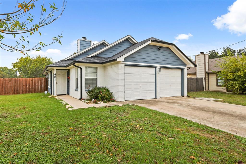 a view of a house with a yard and garage