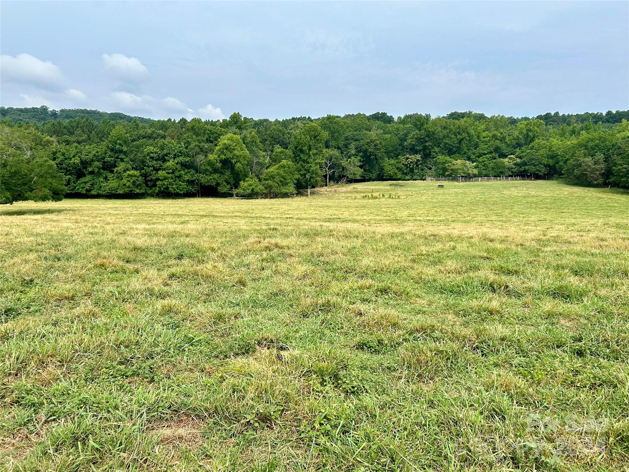 a view of a field with an ocean view