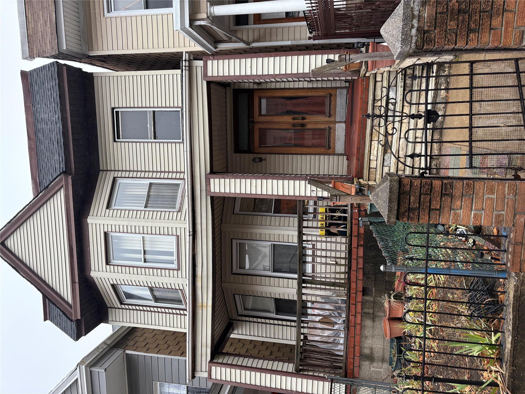 Townhome / multi-family property with covered porch and french doors