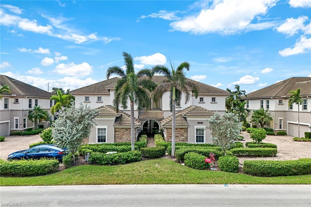 a front view of a house with a garden and plants