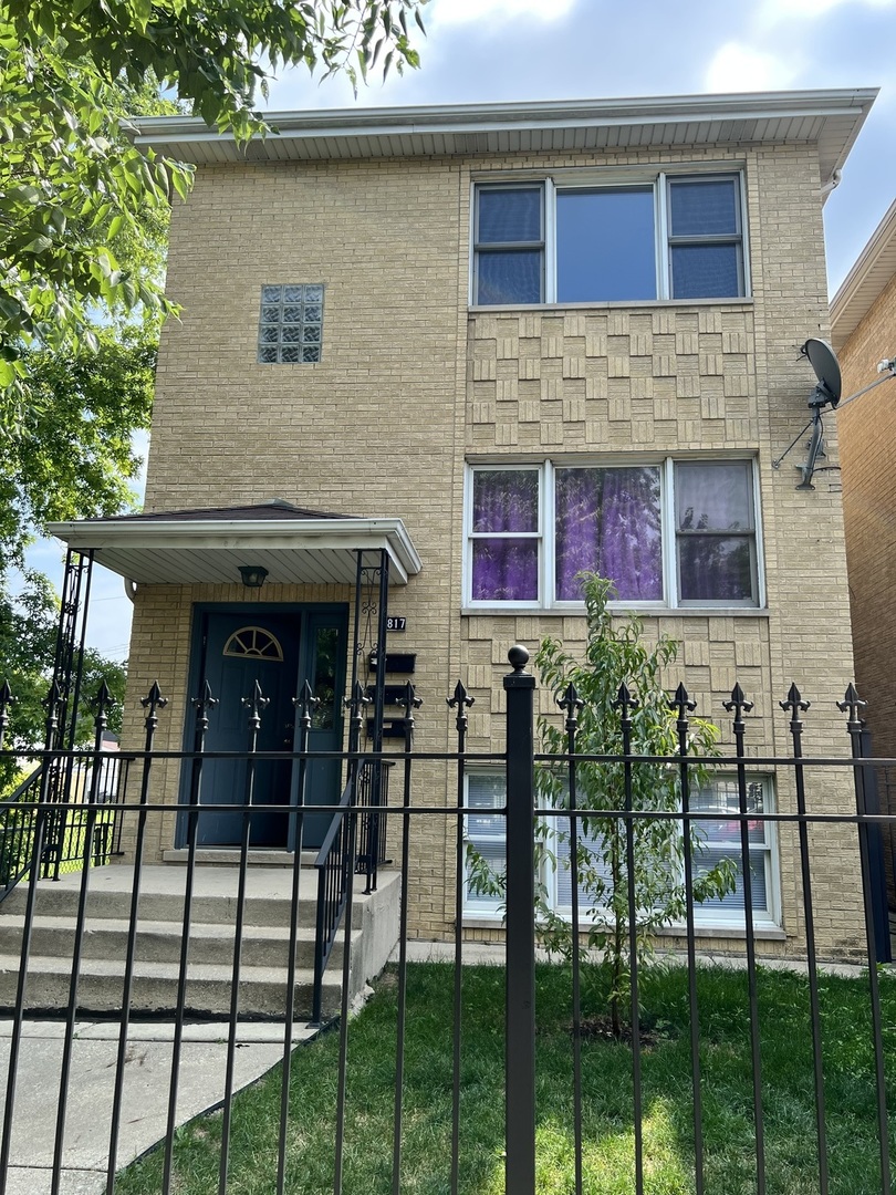 a view of brick house with large windows