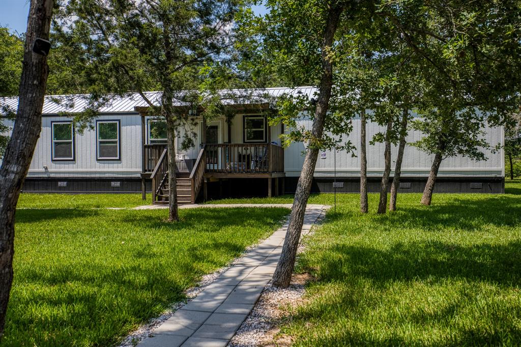 a view of a house with a backyard