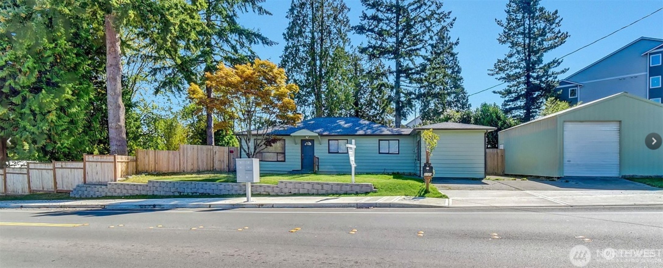 a house that has a tree in front of it