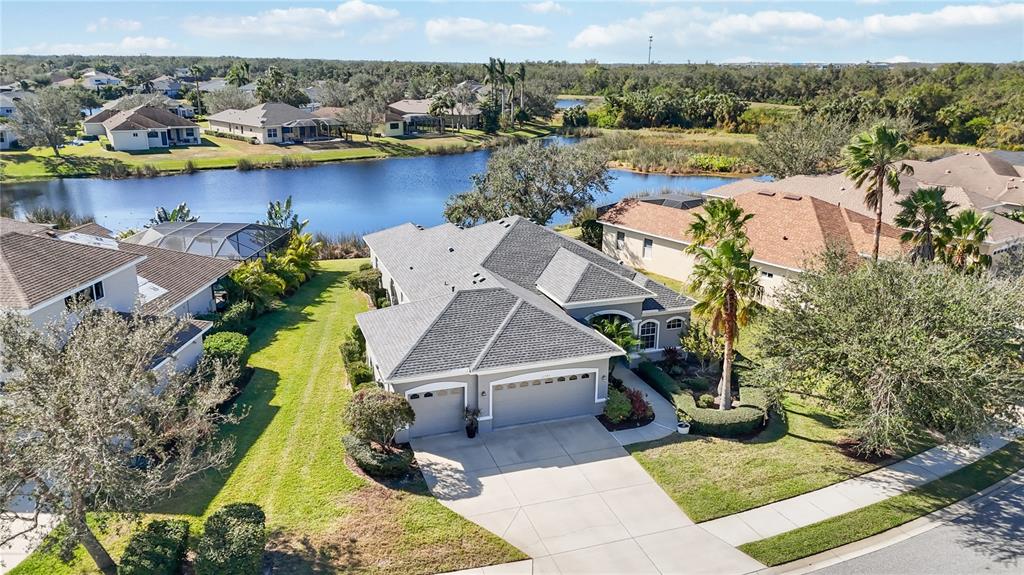 an aerial view of a house with a swimming pool yard and outdoor seating