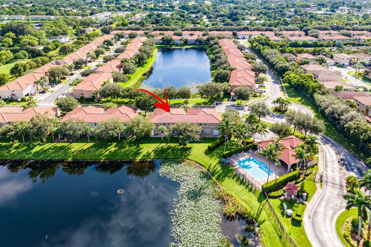 an aerial view of residential houses with outdoor space and swimming pool