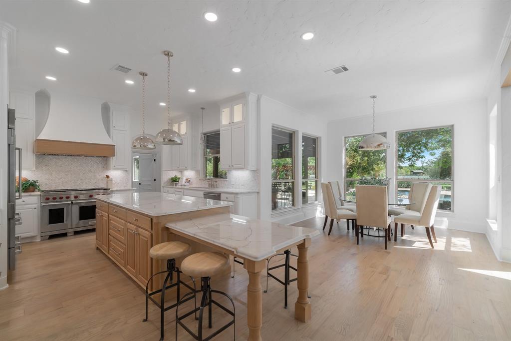 a large kitchen with kitchen island a large island in the center