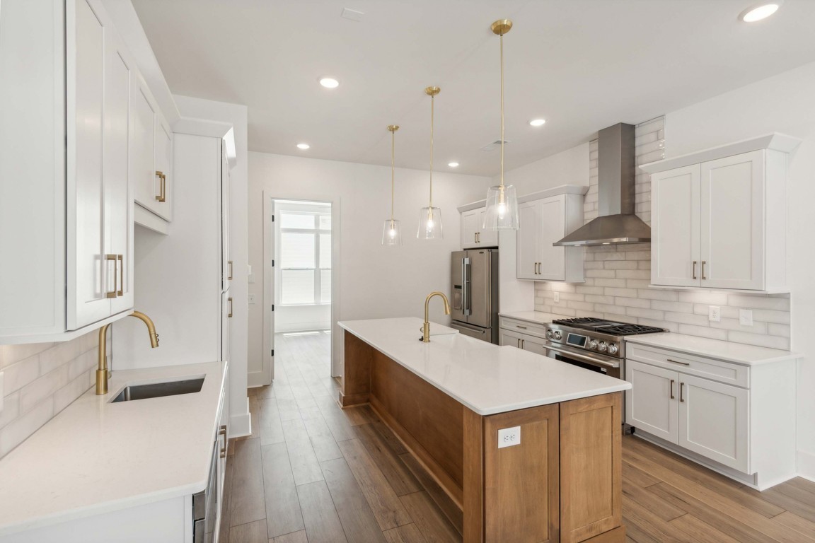 a kitchen with a sink stainless steel appliances and cabinets