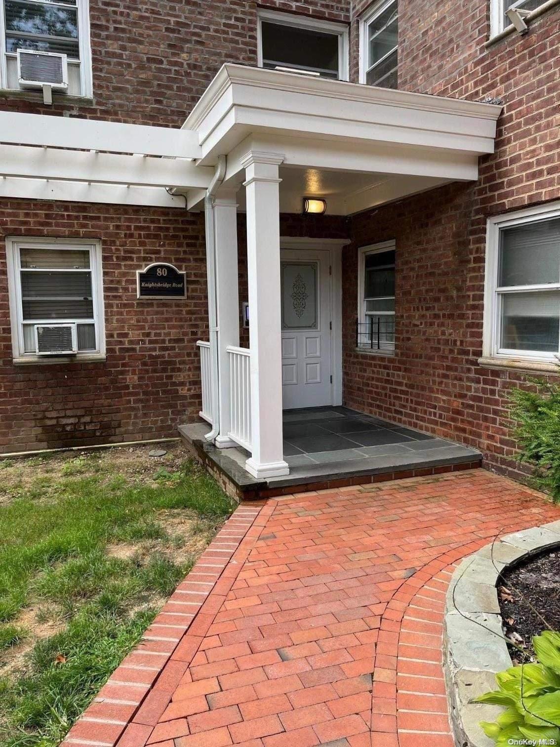 a view of a brick house with many windows