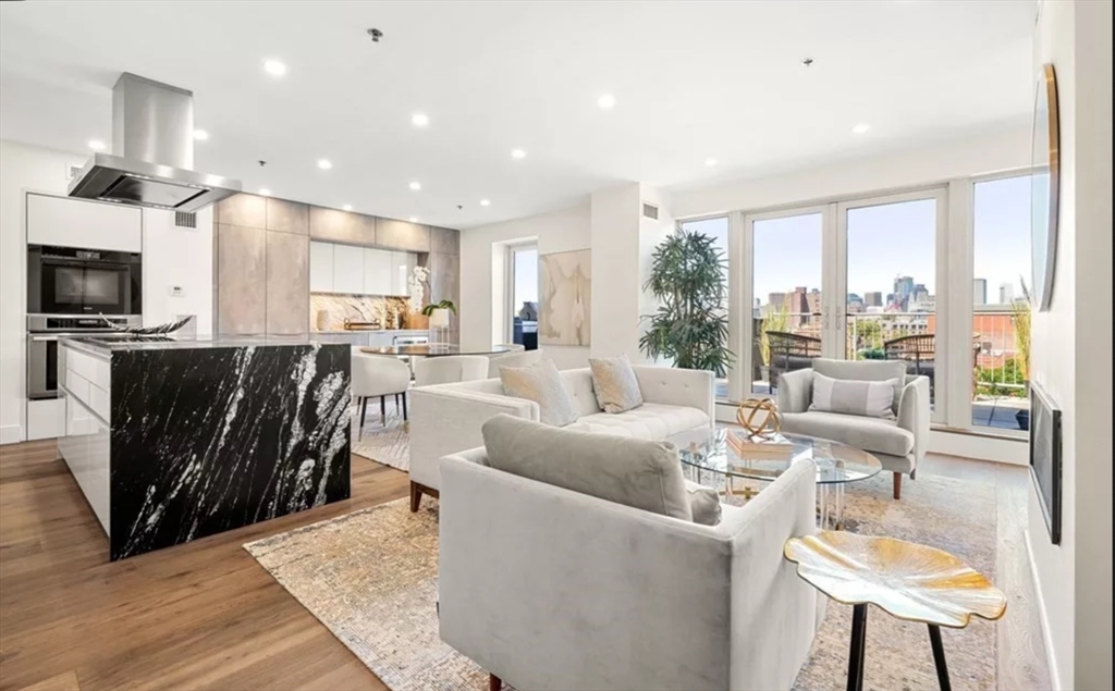 a living room with furniture a large window and a flat screen tv